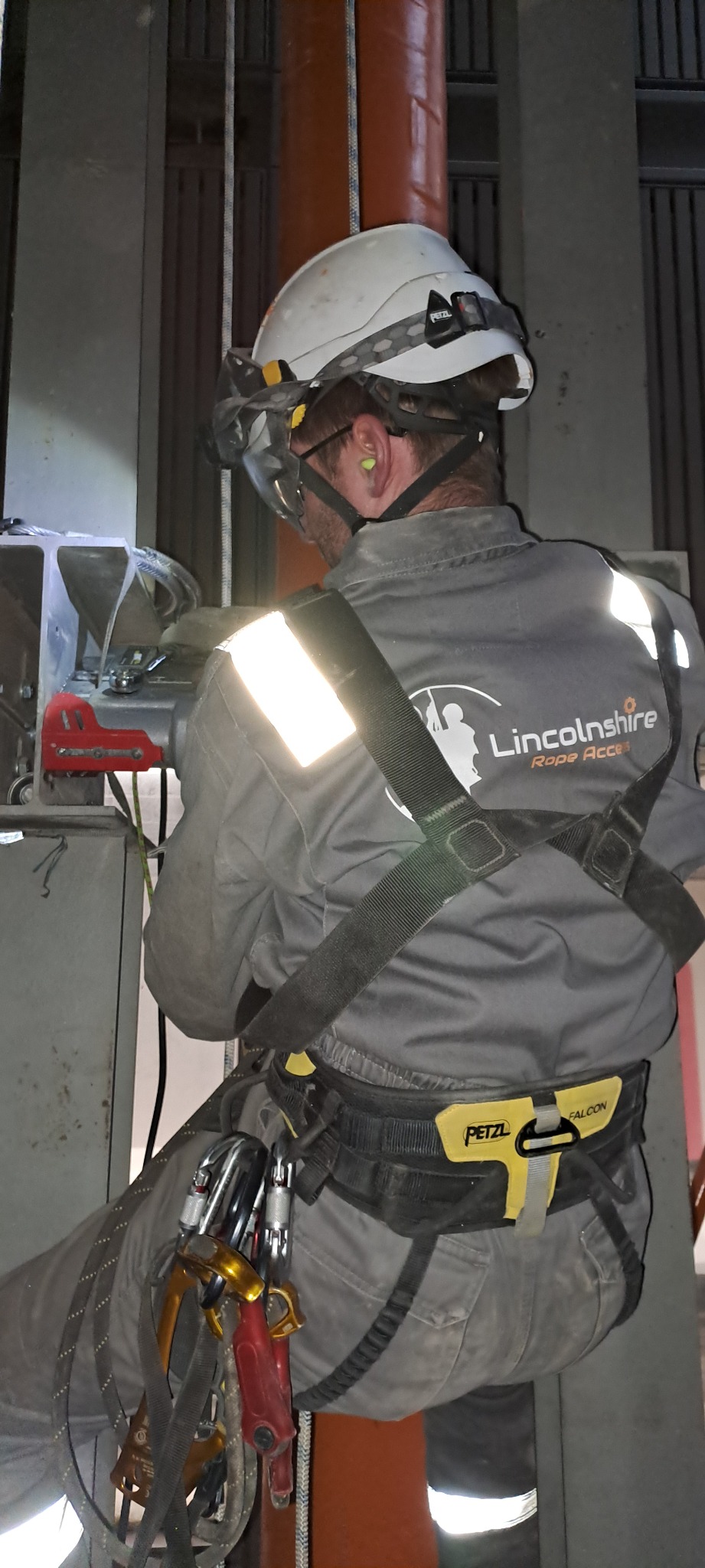 Lincolnshire Rope Access technician in branded workwear and a harness